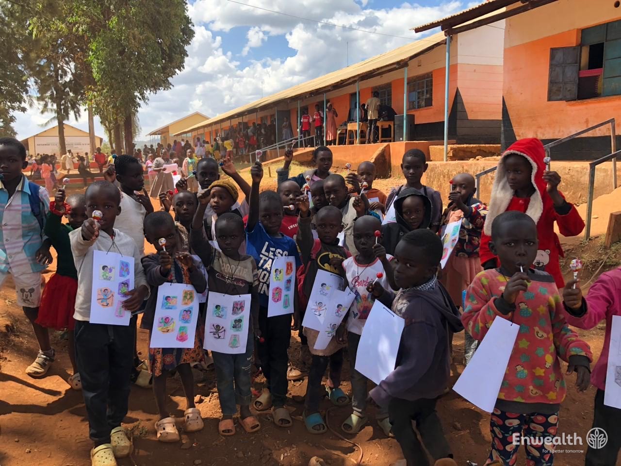 Children outside a school holding printed worksheets.
